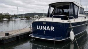 White vinyl boat name on a navy hull