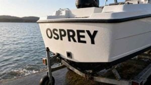 Boat sticker colours in black vinyl on a white fibreglass hull
