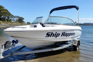 Ship Happens boat name stickers on a white bowrider hull